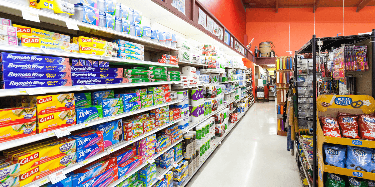 A well-organized grocery aisle filled with various household products and packaging supplies