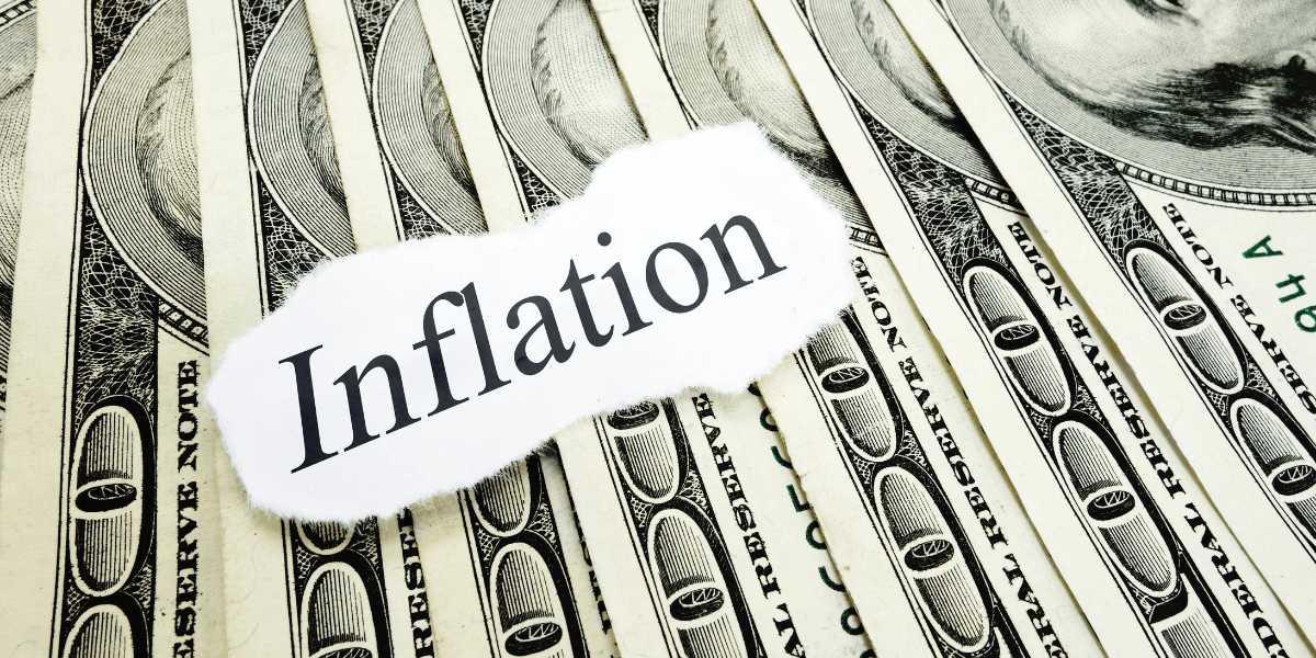 A collage of dollar bills with the word "Inflation" printed on paper overlay.