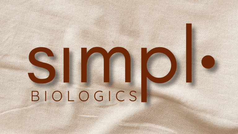 Simpl.bio logo with earthy brown text against a soft beige fabric background, symbolizing a clean, empowering wellness brand for women.