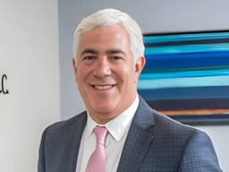 Steven A. Schwartz in a suit at Joel H. Schwartz, P.C. office in Boston.