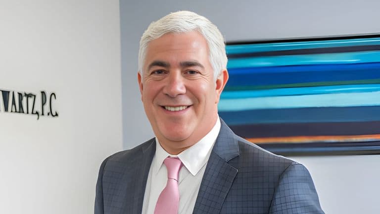Steven A. Schwartz in a suit at Joel H. Schwartz, P.C. office in Boston.