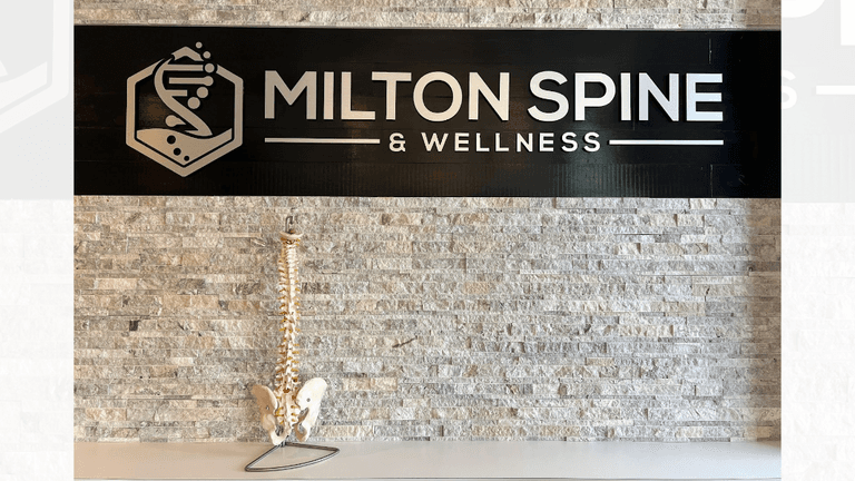 "Milton Spine & Wellness sign showcasing the clinic's holistic health services, including chiropractic care and Kangen Water®."