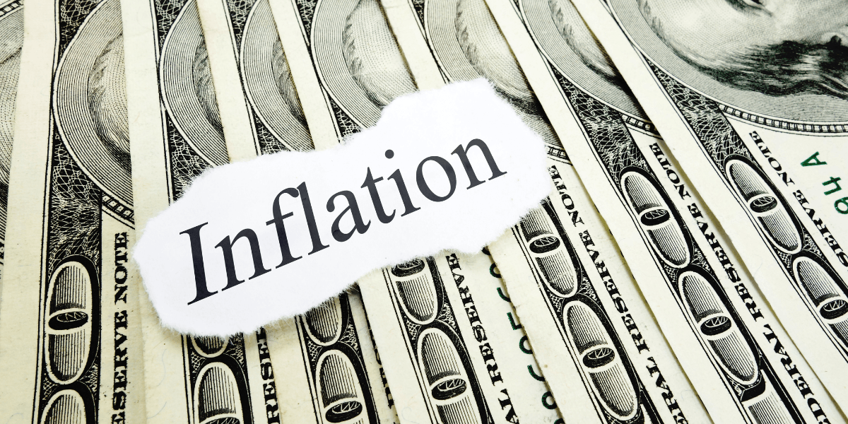 A collage of dollar bills with the word "Inflation" printed on paper overlay.