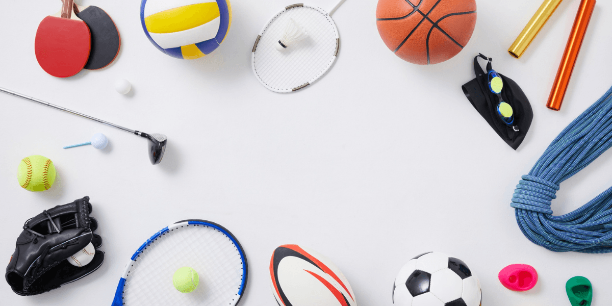 Sports equipment including basketball, soccer ball, tennis racket, baseball glove, and volleyball arranged on a white background.