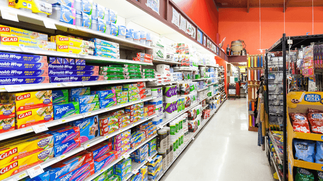 A well-organized grocery aisle filled with various household products and packaging supplies
