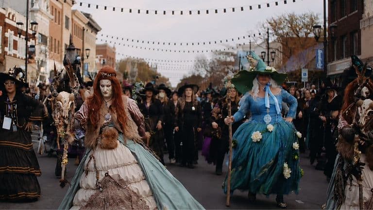 Elaborately dressed witches lead a downtown parade during Sandusky Witches Walk’s Halloween-themed anniversary event.