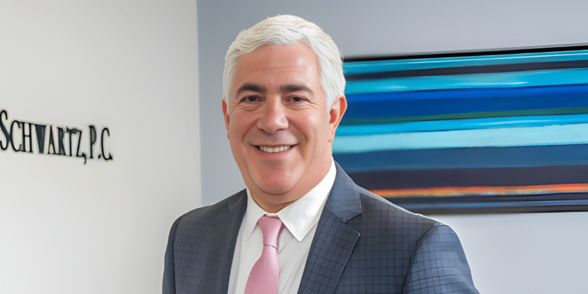 Steven A. Schwartz in a suit at Joel H. Schwartz, P.C. office in Boston.